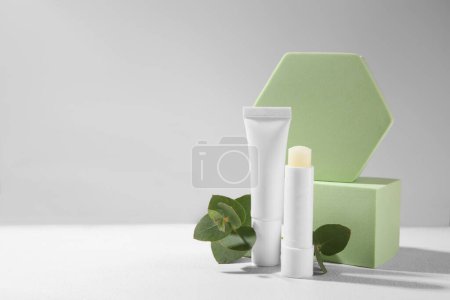 Photo for Stylish presentation of different lip balms on white table, space for text - Royalty Free Image