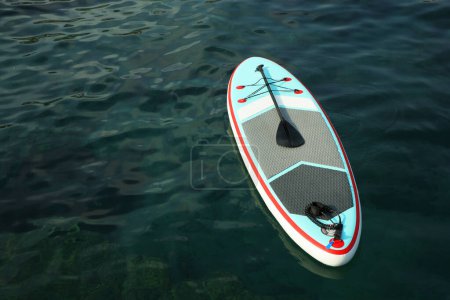 Photo for One SUP board with paddle on water in sea, space for text - Royalty Free Image