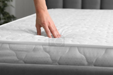 Photo for Man touching soft mattress indoors, closeup view - Royalty Free Image