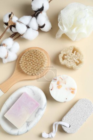 Photo for Bath accessories. Flat lay composition with personal care products and cotton flowers on beige background - Royalty Free Image