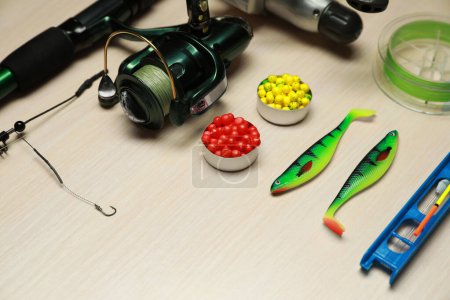 Photo for Modern fishing tackle on wooden background, closeup - Royalty Free Image