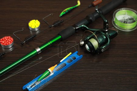 Photo for Modern fishing tackle on dark wooden background - Royalty Free Image