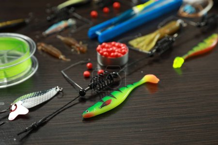 Photo for Fishing tackle on dark wooden background, closeup - Royalty Free Image
