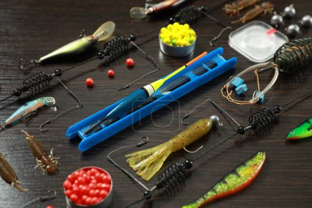 Photo for Fishing tackle on dark wooden background, closeup - Royalty Free Image