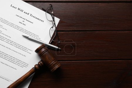 Last Will and Testament, glasses, pen and gavel on wooden table, flat lay. Space for text
