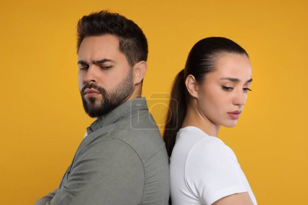 Photo for Portrait of resentful couple on orange background - Royalty Free Image