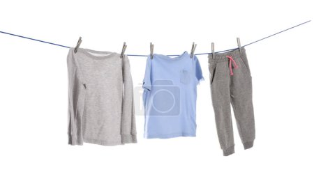 Foto de Different clothes drying on washing line against white background - Imagen libre de derechos