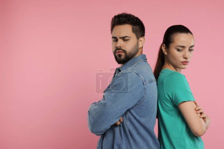 Photo for Resentful couple with crossed arms on pink background, space for text - Royalty Free Image