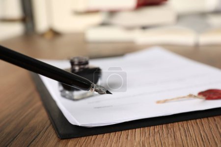 Téléchargez les photos : Document de signature avec stylo plume sur table en bois, gros plan. Contrat notarié - en image libre de droit