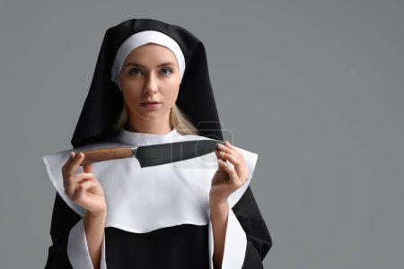 Photo for Woman in nun habit holding knife on grey background. Space for text - Royalty Free Image