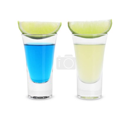 Different shooters in shot glasses and lime wedges isolated on white. Alcohol drink
