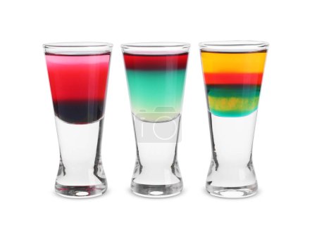 Different shooters in shot glasses isolated on white