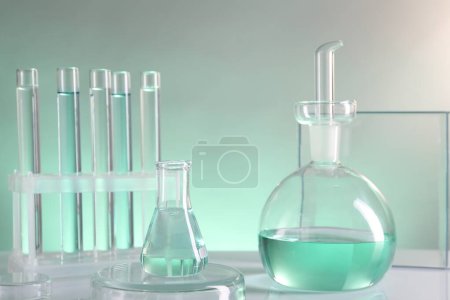 Photo for Laboratory analysis. Different glassware on table against color background - Royalty Free Image