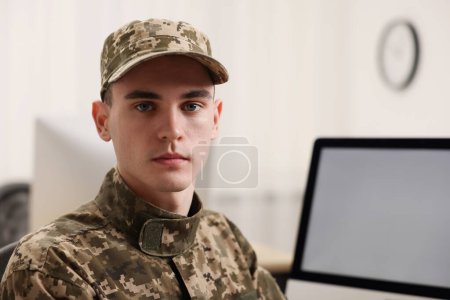 Military service. Portrait of young soldier in office, space for text