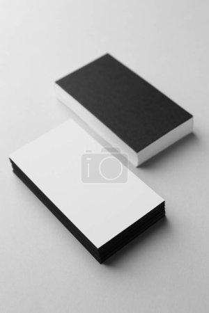 Photo for Blank black and white business cards on light background. Mockup for design - Royalty Free Image