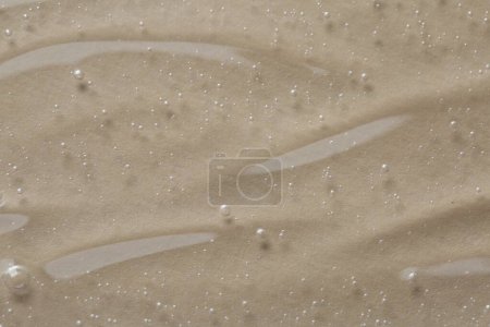 Photo for Clear cosmetic serum on beige background, macro view - Royalty Free Image