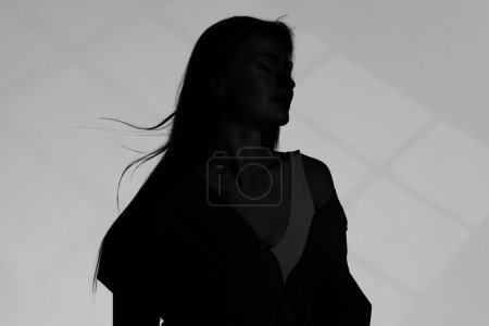 Silhouette of one woman on grey background