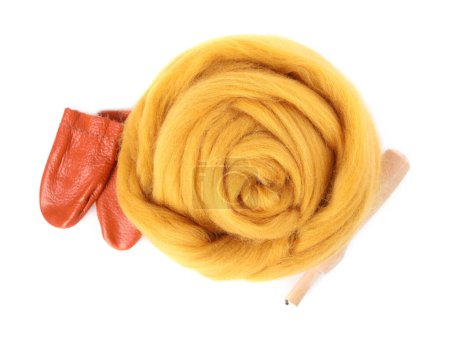 Orange felting wool and tools isolated on white, top view