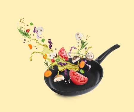 Different vegetables, oil, frying pan in air on pale yellow background