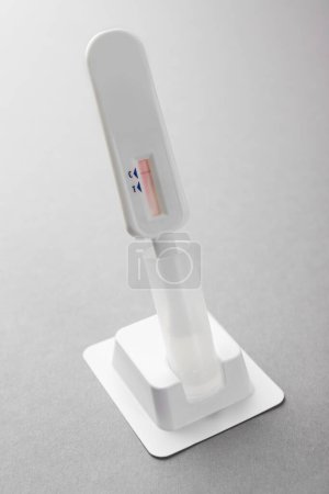 One disposable express test on light grey background