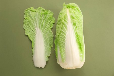 Fresh ripe Chinese cabbage and leaf on olive background, top view