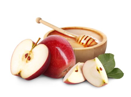 Téléchargez les photos : Miel dans un bol et pommes isolé sur blanc - en image libre de droit