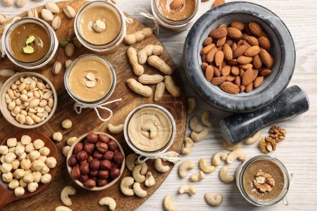 Photo for Making nut butters from different nuts. Flat lay composition on wooden table - Royalty Free Image