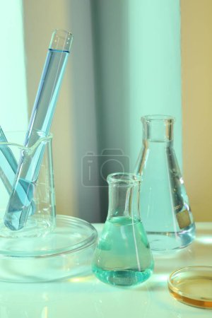 Photo for Laboratory analysis. Different glassware on table against color background - Royalty Free Image