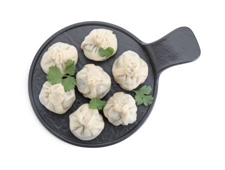 Serving board with tasty fresh khinkali (dumplings) and parsley isolated on white, top view. Georgian cuisine