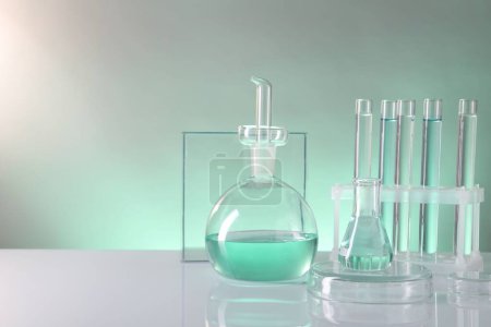 Photo for Laboratory analysis. Different glassware on table against color background, space for text - Royalty Free Image