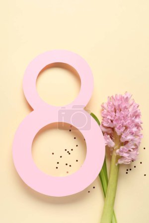 8th of March greeting card design with paper number eight and beautiful flowers on beige background, flat lay. International Women's day