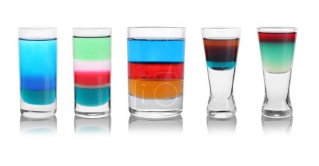 Different shooters in shot glasses isolated on white, set