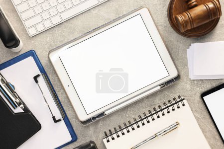 Flat lay composition with modern tablet on light gray textured table. Space for text