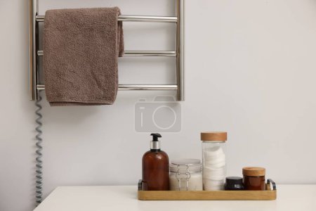 Photo for Stylish bathroom interior with heated towel rail and cosmetic products - Royalty Free Image