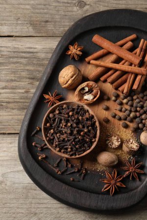 Different spices on wooden table, top view
