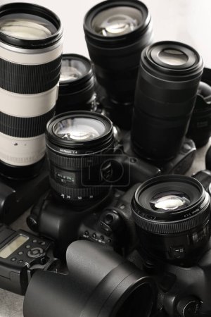 Modern cameras on table, closeup. Professional photography equipment