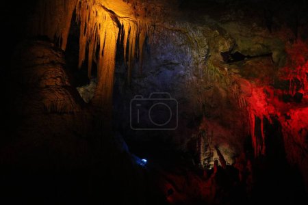 Picturesque view of many stalactite and stalagmite formations in cave