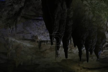 Malerischer Blick auf viele Tropfsteinformationen in dunkler Höhle