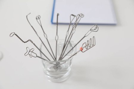 Set of different logopedic probes in holder on light table. Speech therapist's tools