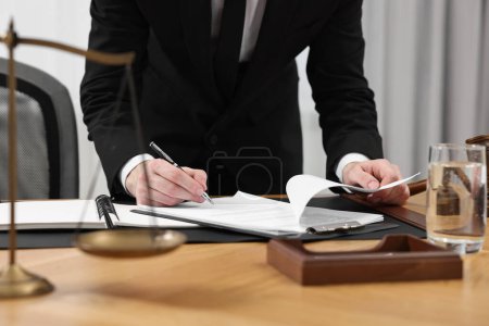 Photo for Lawyer working with documents at wooden table indoors, closeup - Royalty Free Image