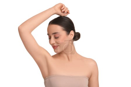 Beautiful woman showing armpit with smooth clean skin on white background