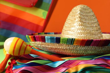 Composition avec chapeau de sombrero mexicain, poncho et maracas sur la table, gros plan
