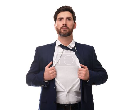 Confident businessman wearing superhero costume under suit on white background