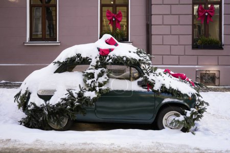 Festively decorated car on city street in winter