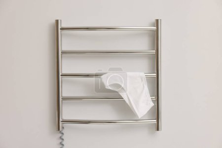 Photo for Heated towel rail with underwear on white wall - Royalty Free Image