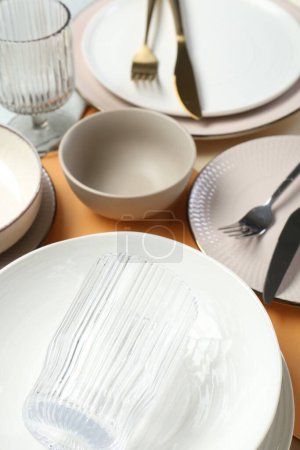Photo for Clean plates, bowls, glass and cutlery on table - Royalty Free Image