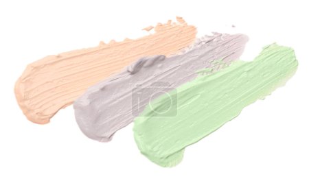 Photo for Strokes of pink, green and purple color correcting concealers isolated on white, top view - Royalty Free Image
