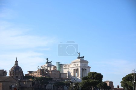 Rome, Italy - February 4, 2024 : Santi Luca e Martina church and Victor Emmanuel II monument outdoors