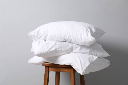 Soft pillows on chair neal light grey wall