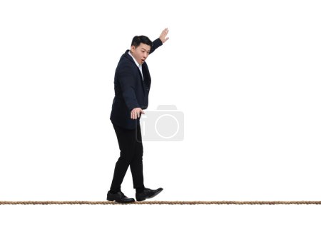 Photo for Risks and challenges of owning business. Man balancing on rope against white background - Royalty Free Image